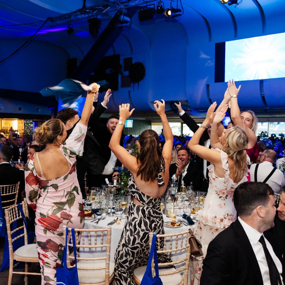 People applauding at an awards ceremony at BHAFC