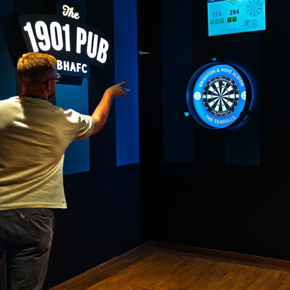 Someone playing darts at 1901 Pub