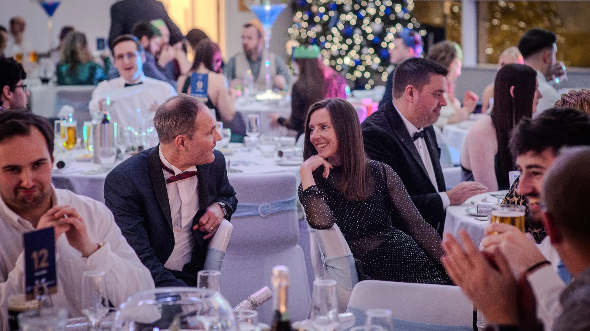 Two people chatting at a Christmas sharer party