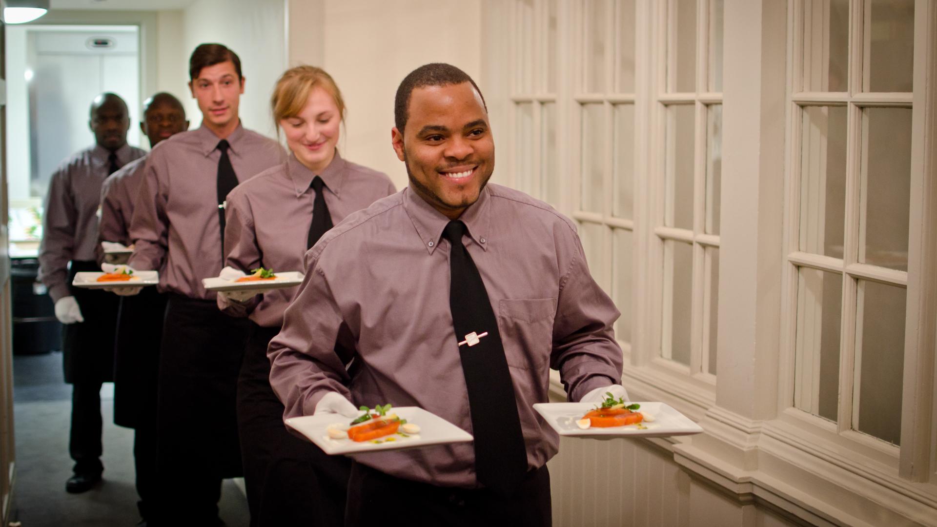 waiters serving food at event
