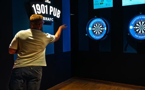 Someone playing darts at 1901 Pub
