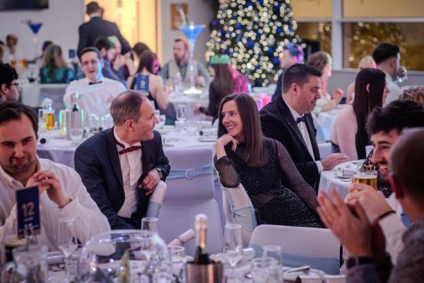 Two people chatting at a Christmas sharer party
